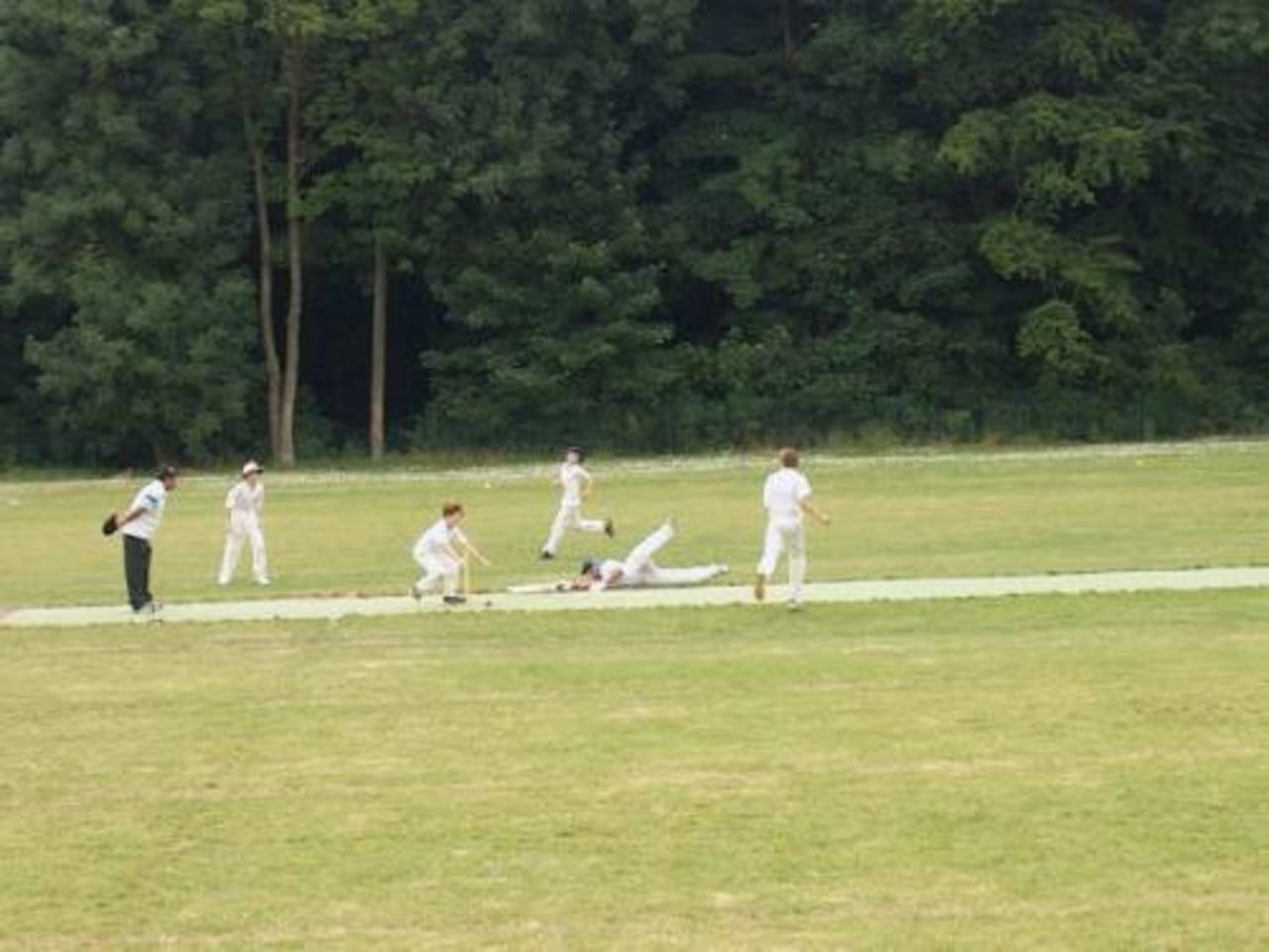 An Antwerp Indians Under-13 batsman makes a great dive for his crease
