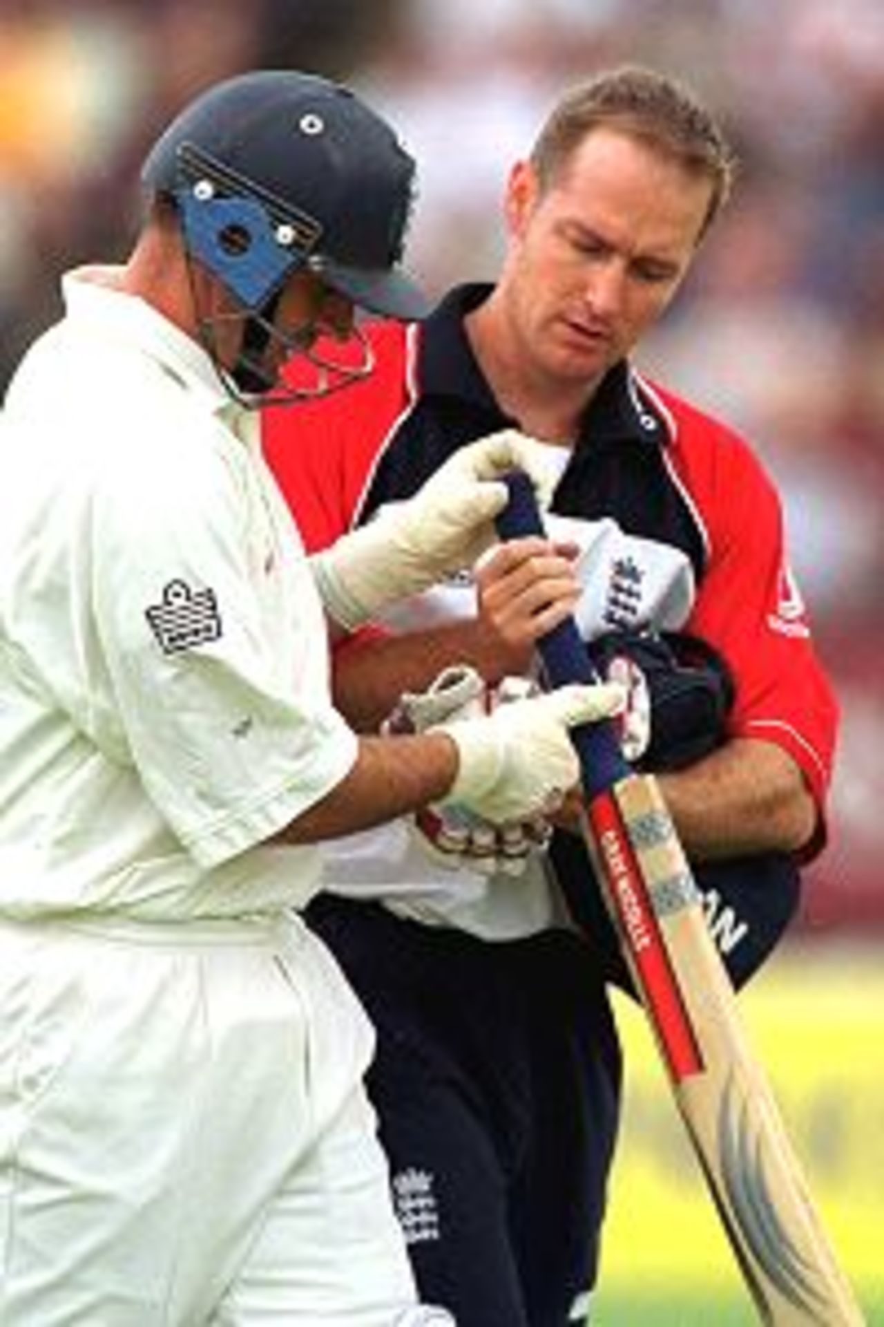 Nasser Hussain of England is treated after being hit on the hand off the ball of Jason Gillespie of Australia during the fourth day of the England v Australia first test match at Edgbaston, Birmingham.