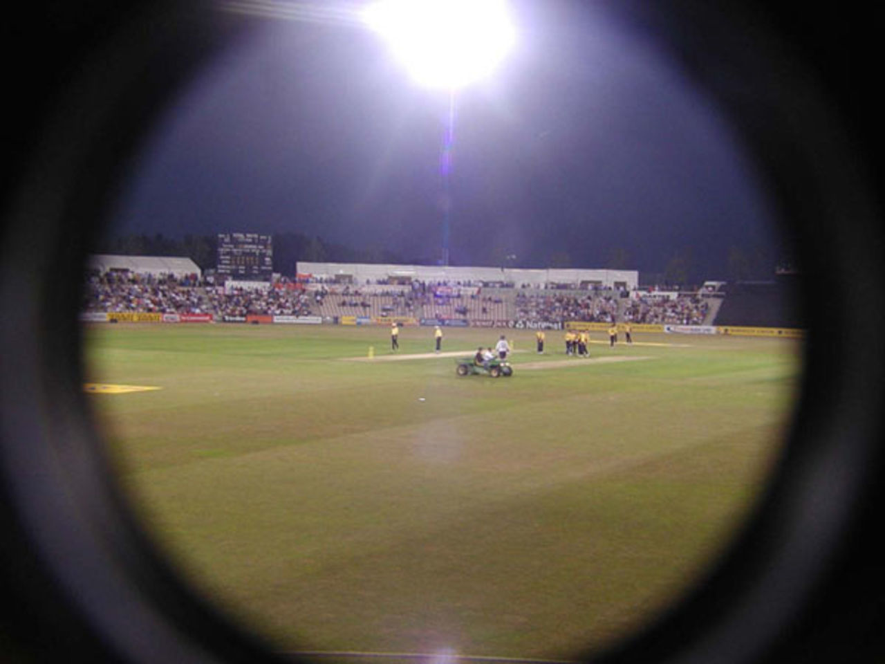 Hampshire scorer and photographer looks through the lens at the Day/Night match