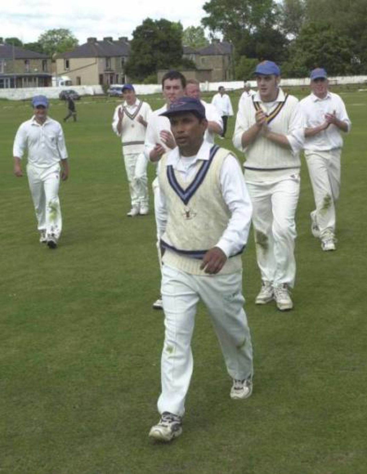 Mujtaba is applauded off by his colleagues after taking 9-61