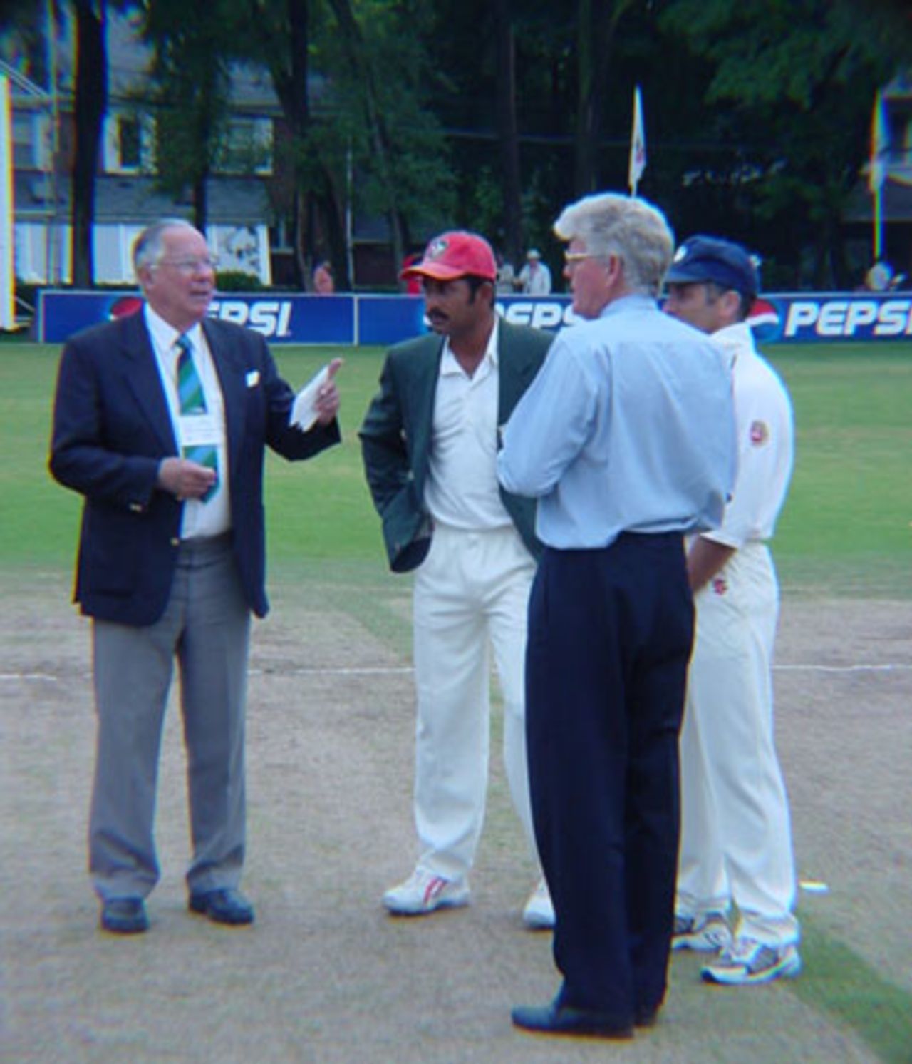 West Indian match referee Jackie Hendriks about to toss the coin for the ICC Trophy World Cup Qualifying Final. Canadian captain Joe Harris, television commentator and former South African Test batsman Barry Richards and Scottish captain George Salmond look on. ICC Trophy 2001: Canada v Scotland at Toronto Cricket, Skating and Curling Club, 17 July 2001.