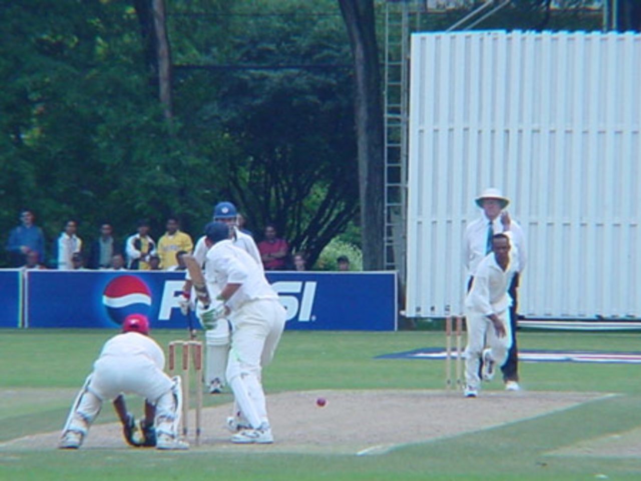 Canadian medium pace bowler Nicholas Degroot bowls to Scottish batsman Drew Parsons. Wicket-keeper Ashish Bagai, batsman George Salmond (obscured) and Australian umpire Darrell Hair look on. ICC Trophy 2001: Canada v Scotland, Toronto Cricket, Skating and Curling Club, 17 July 2001.