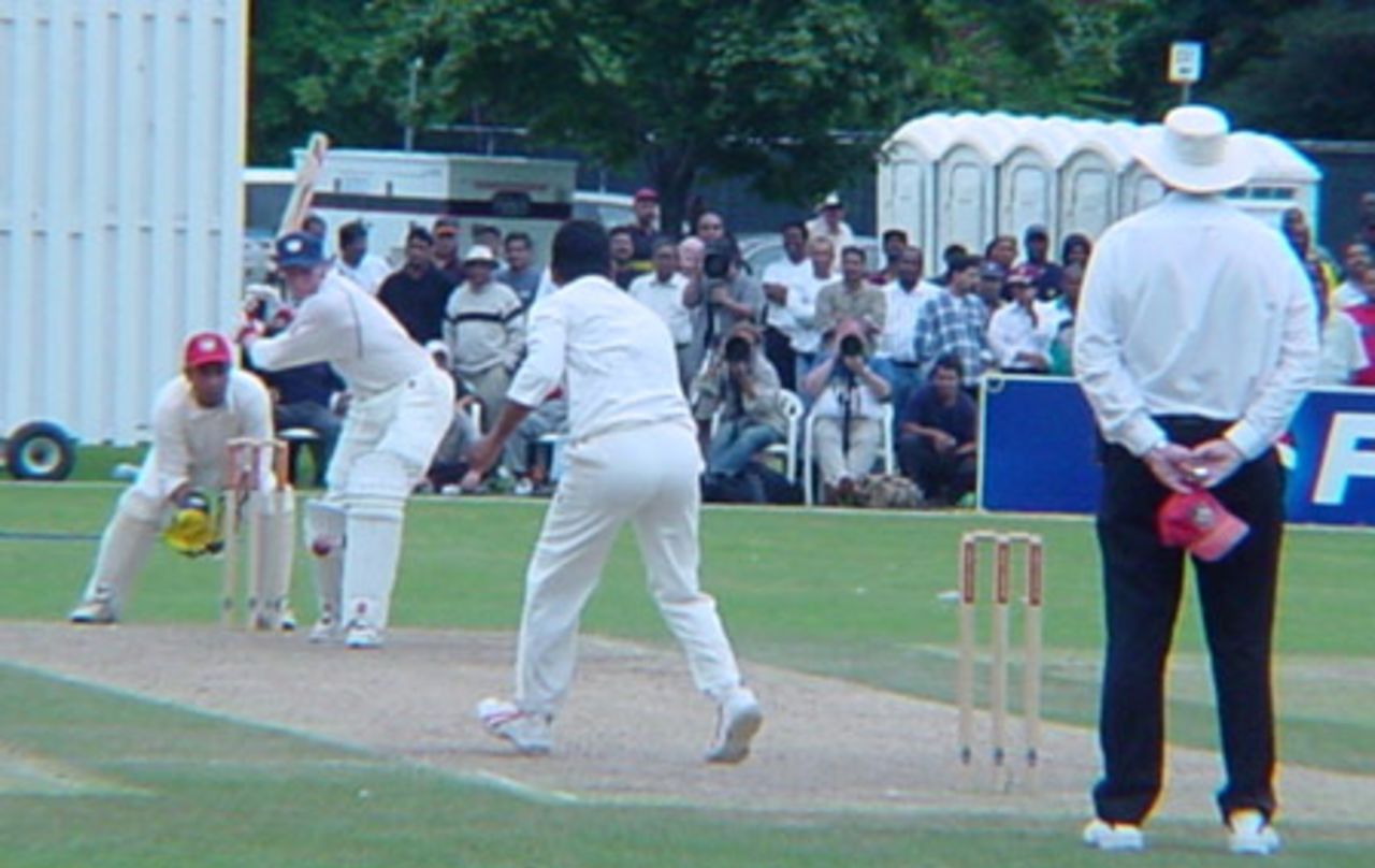 Scottish batsman Craig Wright shapes to loft a delivery from Canadian off spinner Joe Harris over midwicket during his innings of 25. Wicket-keeper Ashish Bagai and Australian umpire Darrell Hair look on. ICC Trophy 2001: Canada v Scotland, Toronto Cricket, Skating and Curling Club, 17 July 2001.