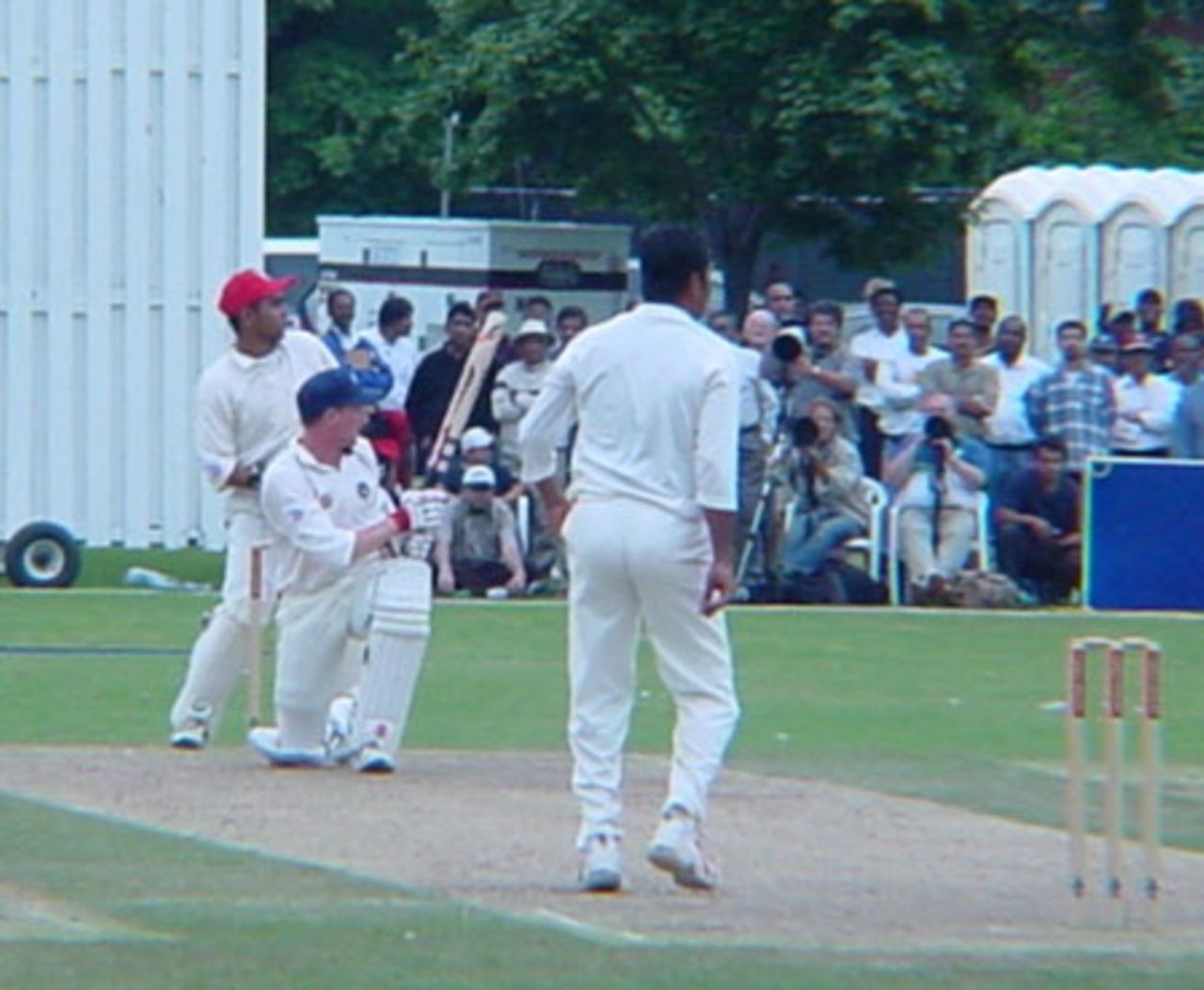 Scottish batsman Craig Wright sweeps a delivery from Canadian off spinner Joe Harris during his innings of 25. Wicket-keeper Ashish Bagai follows the path of the ball. ICC Trophy 2001: Canada v Scotland, Toronto Cricket, Skating and Curling Club, 17 July 2001.