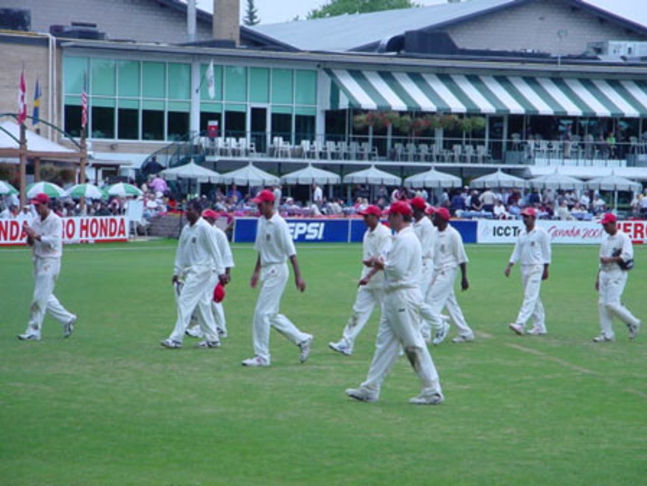 The Canadian team walk off the field after restricting Scotland to 176 for nine in their 50 overs batting first. ICC Trophy 2001: Canada v Scotland at Toronto, Cricket, Skating and Curling Club, 17 July 2001.