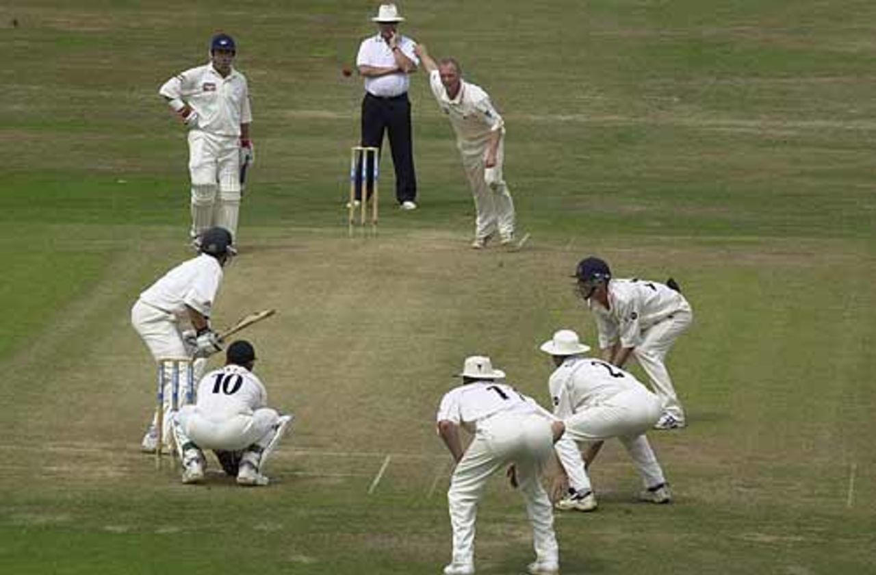 Gary Keedy bowls to a field of vulture like companions, with Wood the batter, CricInfo Championship, 2nd Day, 29 July 2001