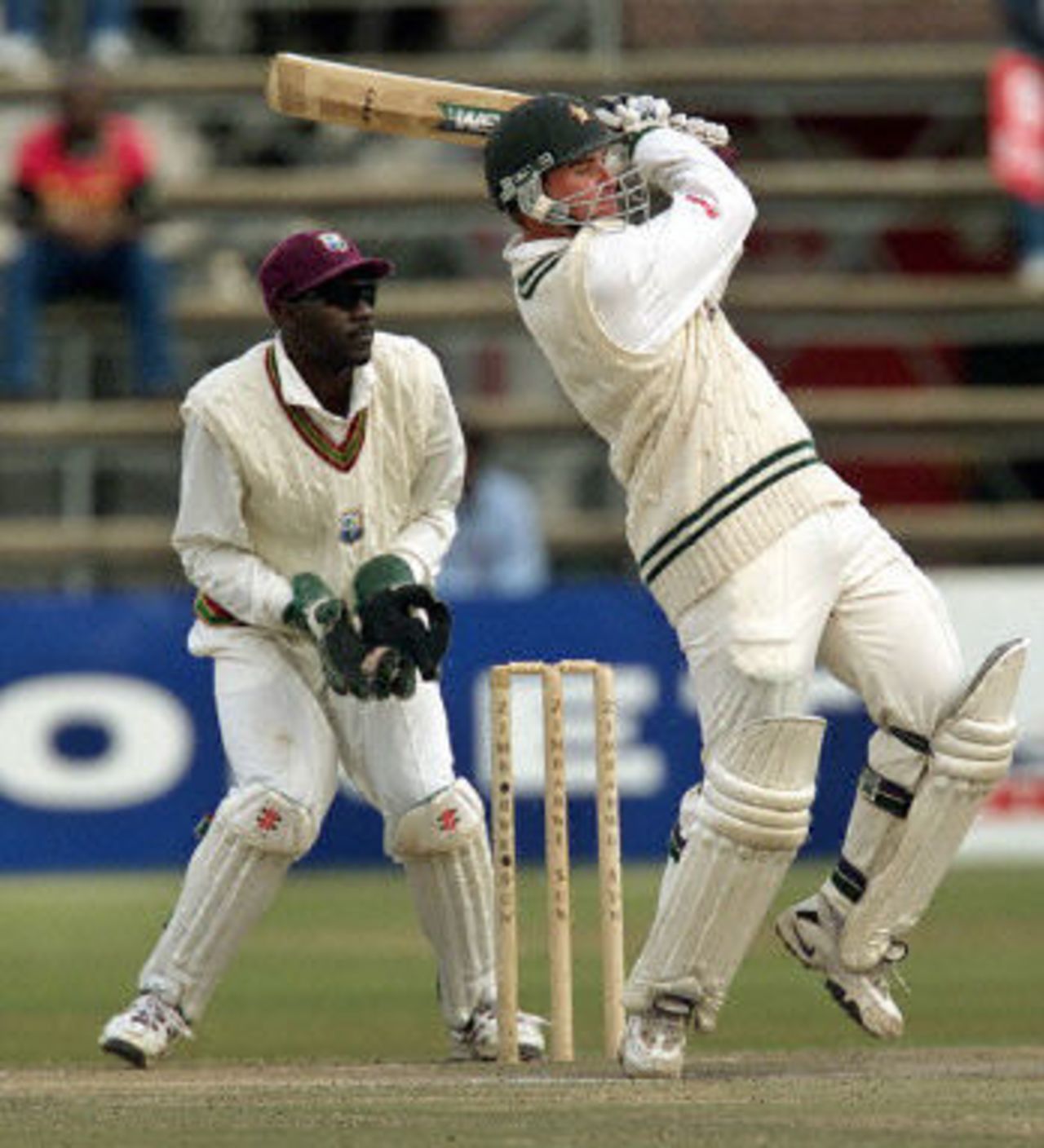 Craig Wishart drives to the boundary watched by Courtney Brown, West Indies v Zimbabwe 2nd Test at Harare, 27-31 July 2001.