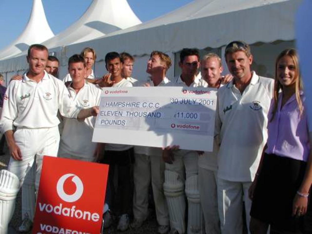 Hampshire players celebrate after receiving a cheque for £11,000 following their famous victory over Australia.