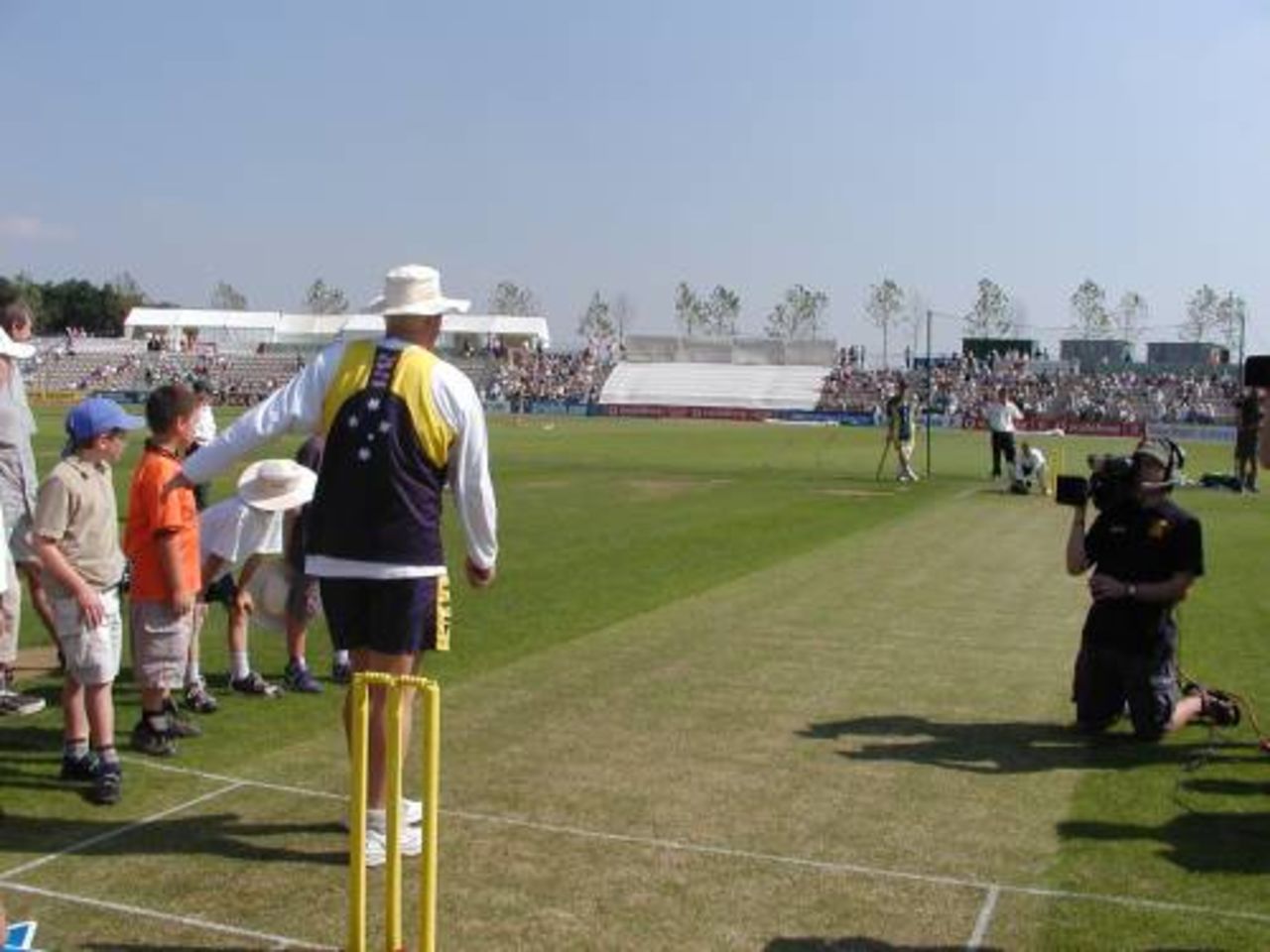 Shane Warne shows the boys and girl some spinning techniques during the Channel 4 Road show at The Rose Bowl
