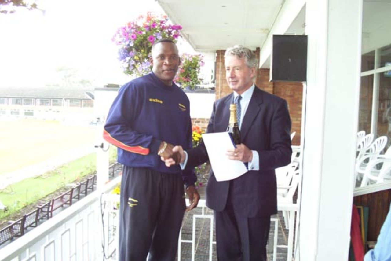 Devon Malcolm receives the Bland Bankart Player of the Month Award from Mr Gilbert Bland