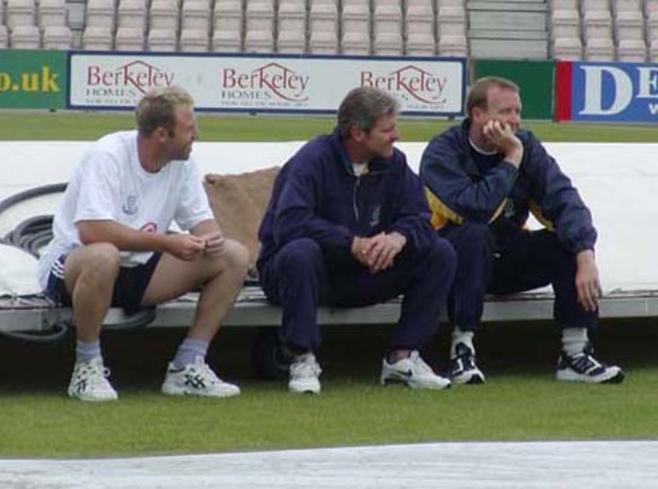 Robin Smith, Shaun Udal and Chris Adams waiting for the umpires to decide on their Championship match