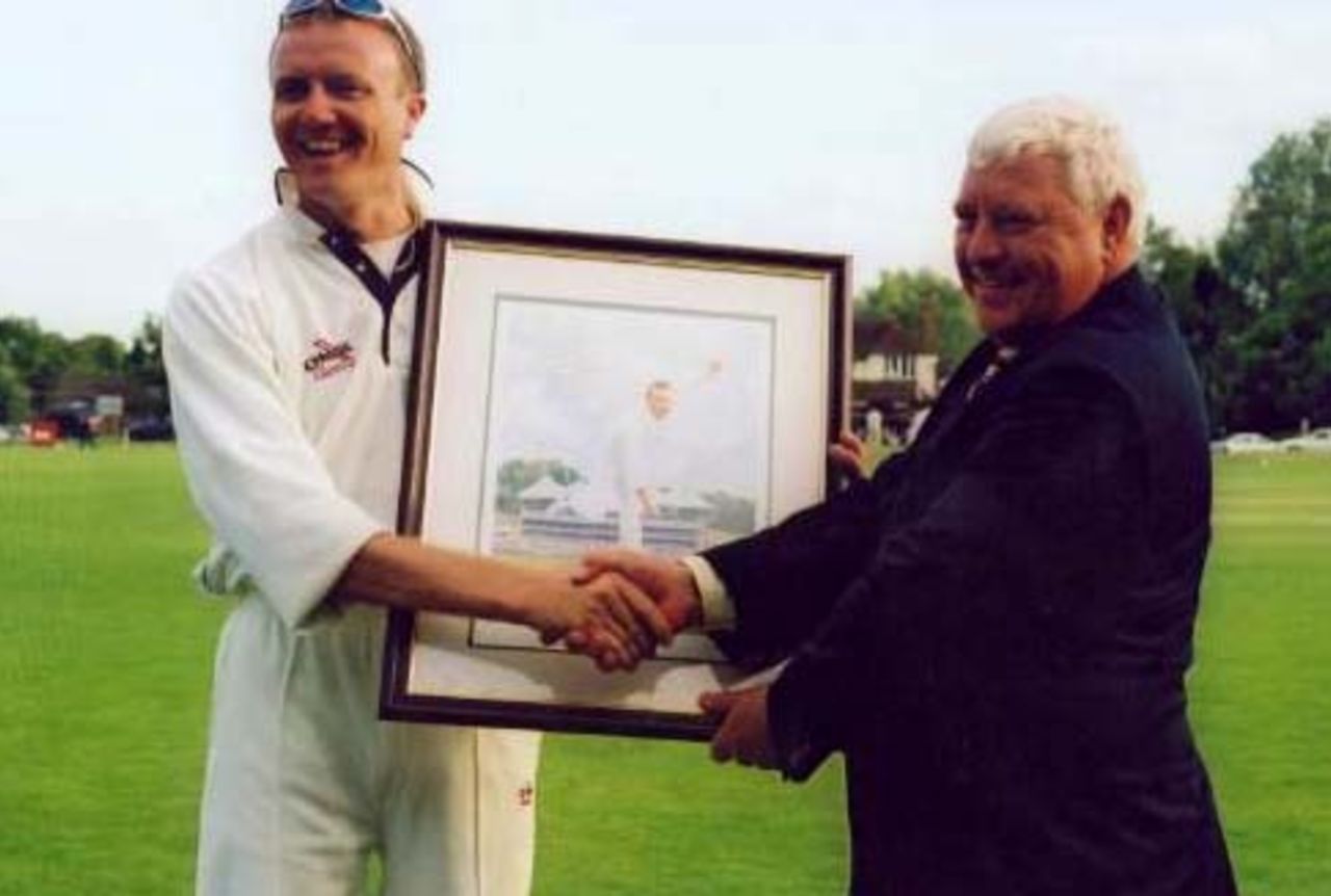 Shaun Udal presents Eversley president with benefit portrait