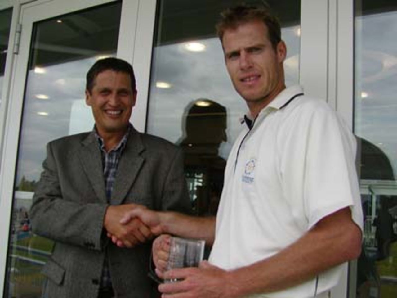Neil Johnson receives the Hampshire player of the month (June) award from Courage breweries