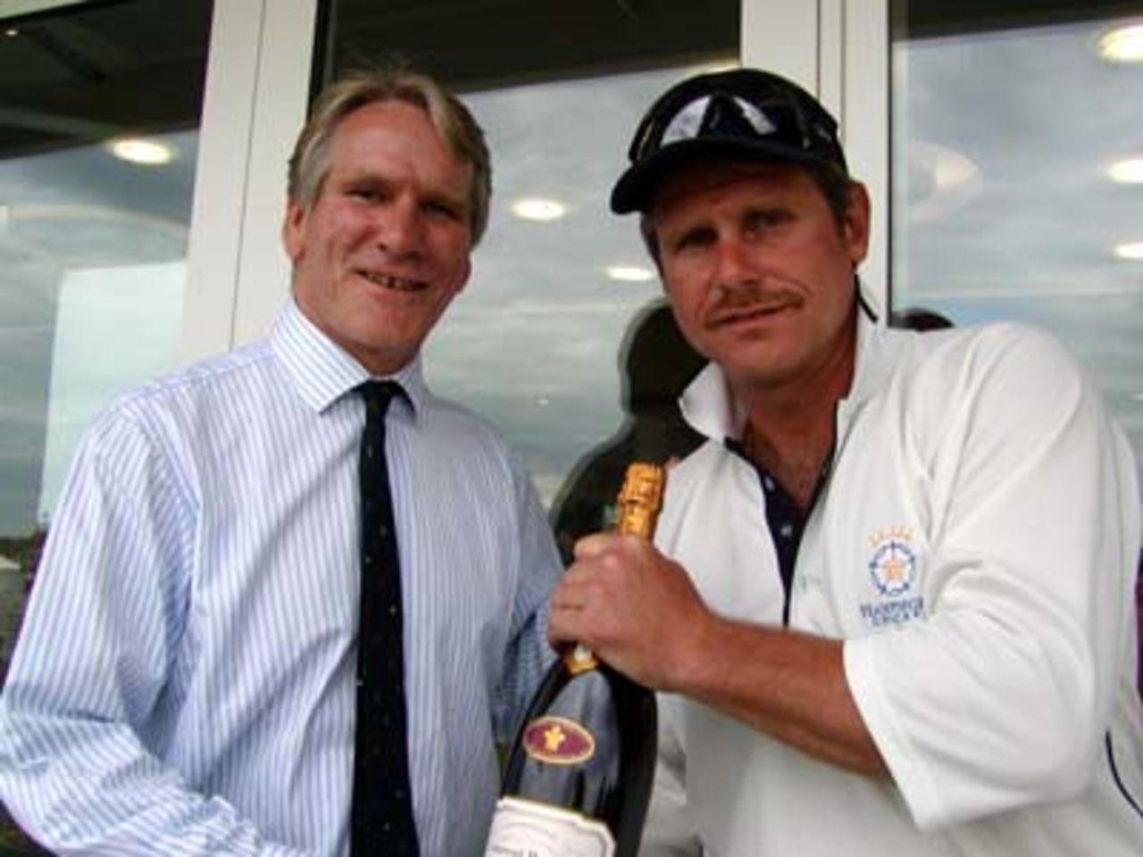 Lawrence Ridler of Laurent Perrier champagne presents Robin Smith with a magnum of champage for his Performance of the Month prize for June. His 48* innings against Somerset at Bath was a match saving effort.