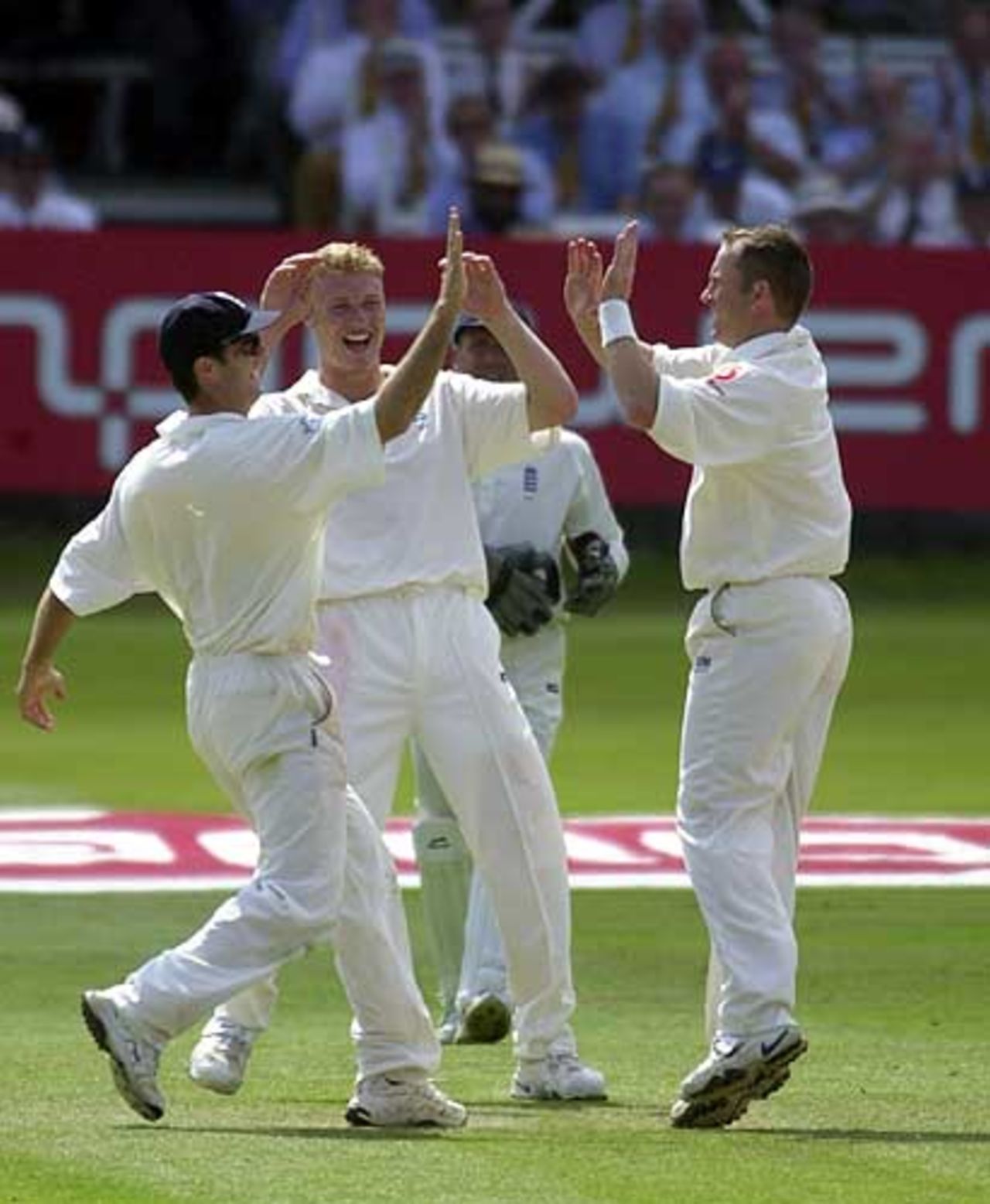 White, right, Flintoff and Vaughan, left, celebrate White bowling out Kumble, England v India 1st npower Test at Lord's