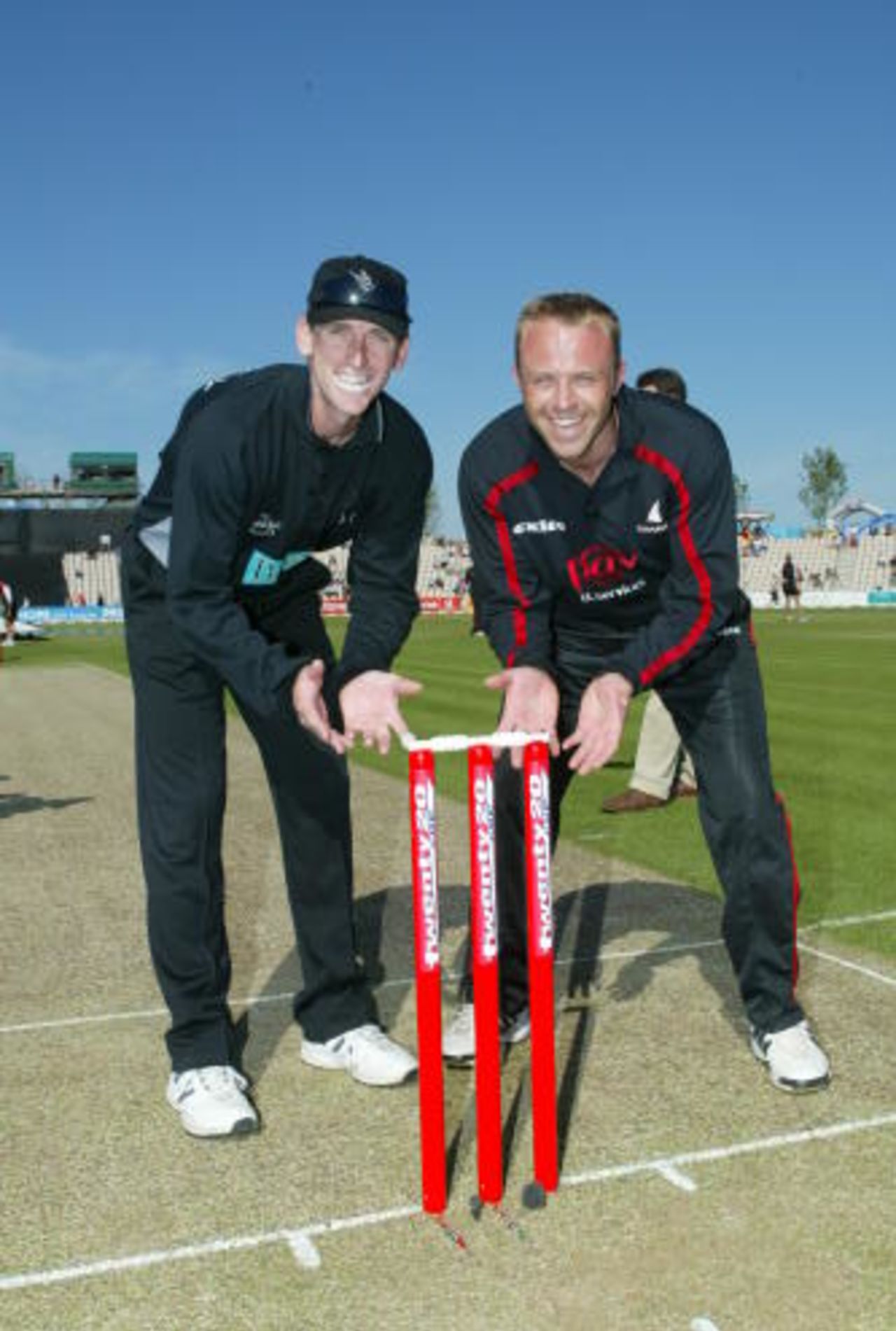 Captains pose with the special Twenty20 stumps