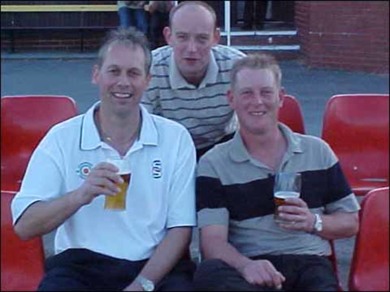 Mike Ingham and Graham Knowles (with runner Andrew Smith ) relax after breaking the all time league record partnership with a 273 run stand for Haslingden against Church at Haslingden on July 12th.
