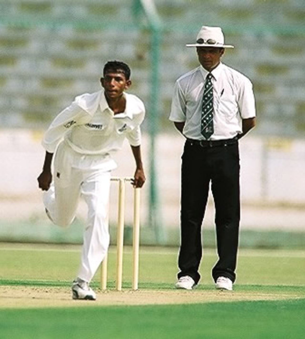 Maldives bowler Habeeb in his follow through, Nepal Under-19s v Maldives Under-19s at National Stadium Karachi, Youth Asia Cup 2003, 14 July 2003.