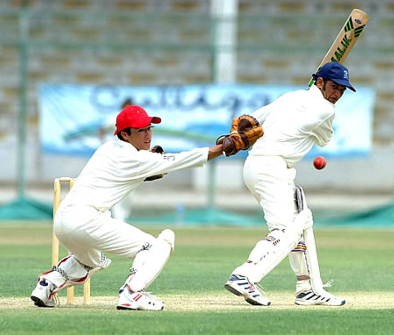 Oman's Adnan Ilyas guides the ball past Hong Kong 'keeper Matthew Lind on way to his unbeaten 168,  Hong Kong Under-19s v Oman Under-19s at National Stadium Karachi, Youth Asia Cup 2003, 15 July 2003.