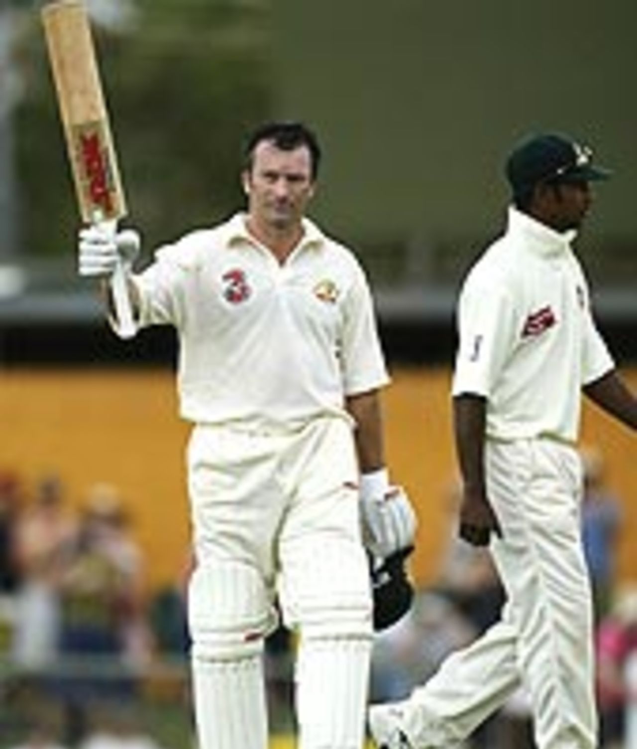 Steve Waugh acknowledges the applause after reaching his hundred against Bangladesh