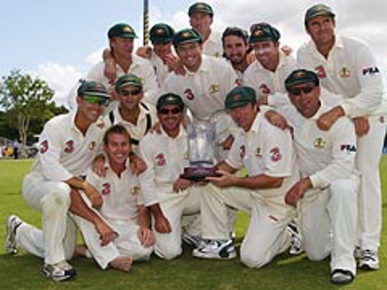 The Australian team celebrate after completing their 2-0 series win over Bangladesh with an innings victory at Cairns, July 28, 2003