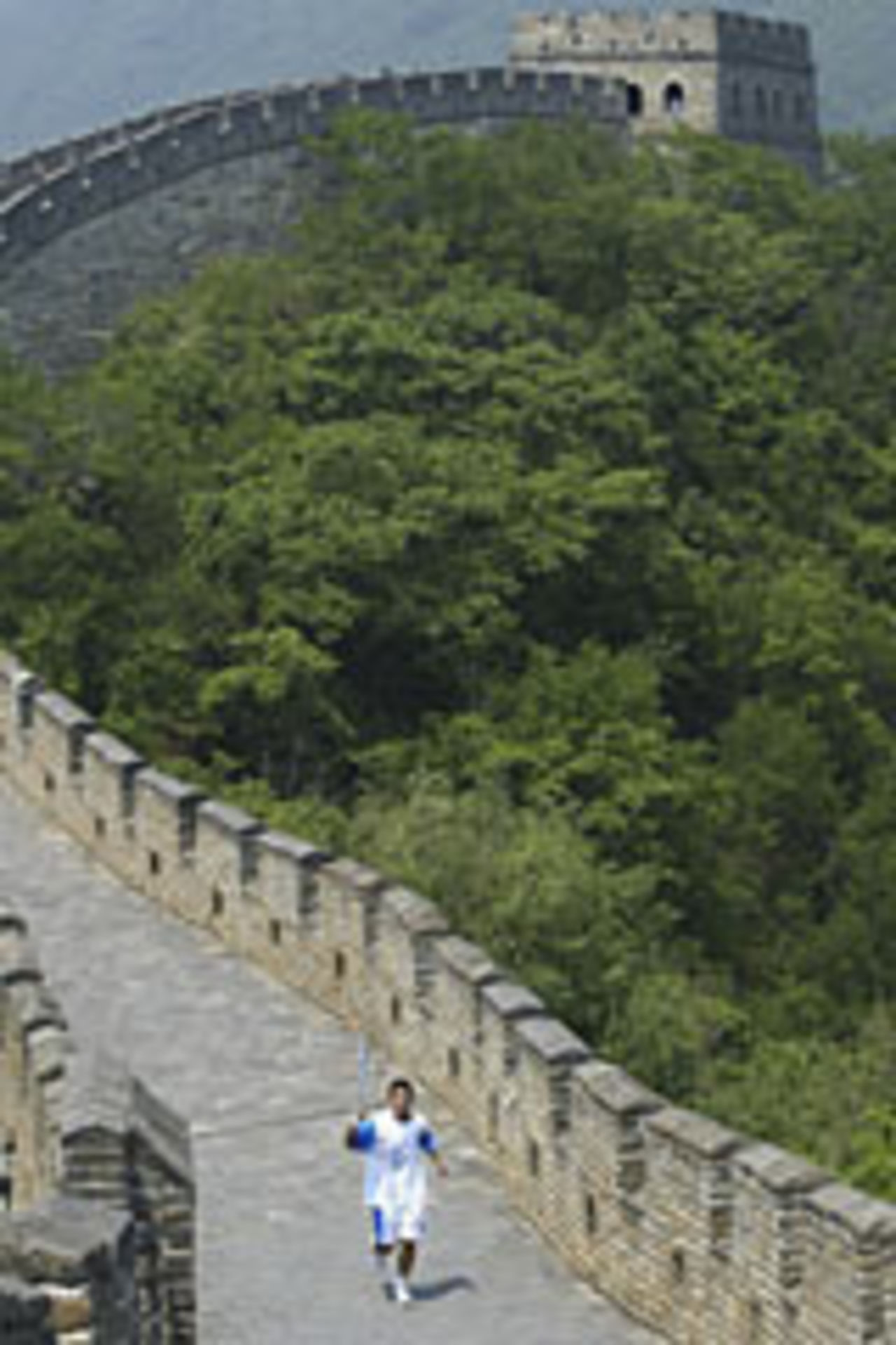 Runner carrying the Olympic flame on the Great Wall, June 2004