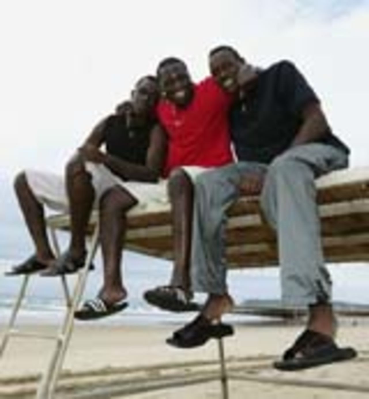 David, Kennedy and Collins Obuya relax on the beach, Cape Town, March 19, 2003
