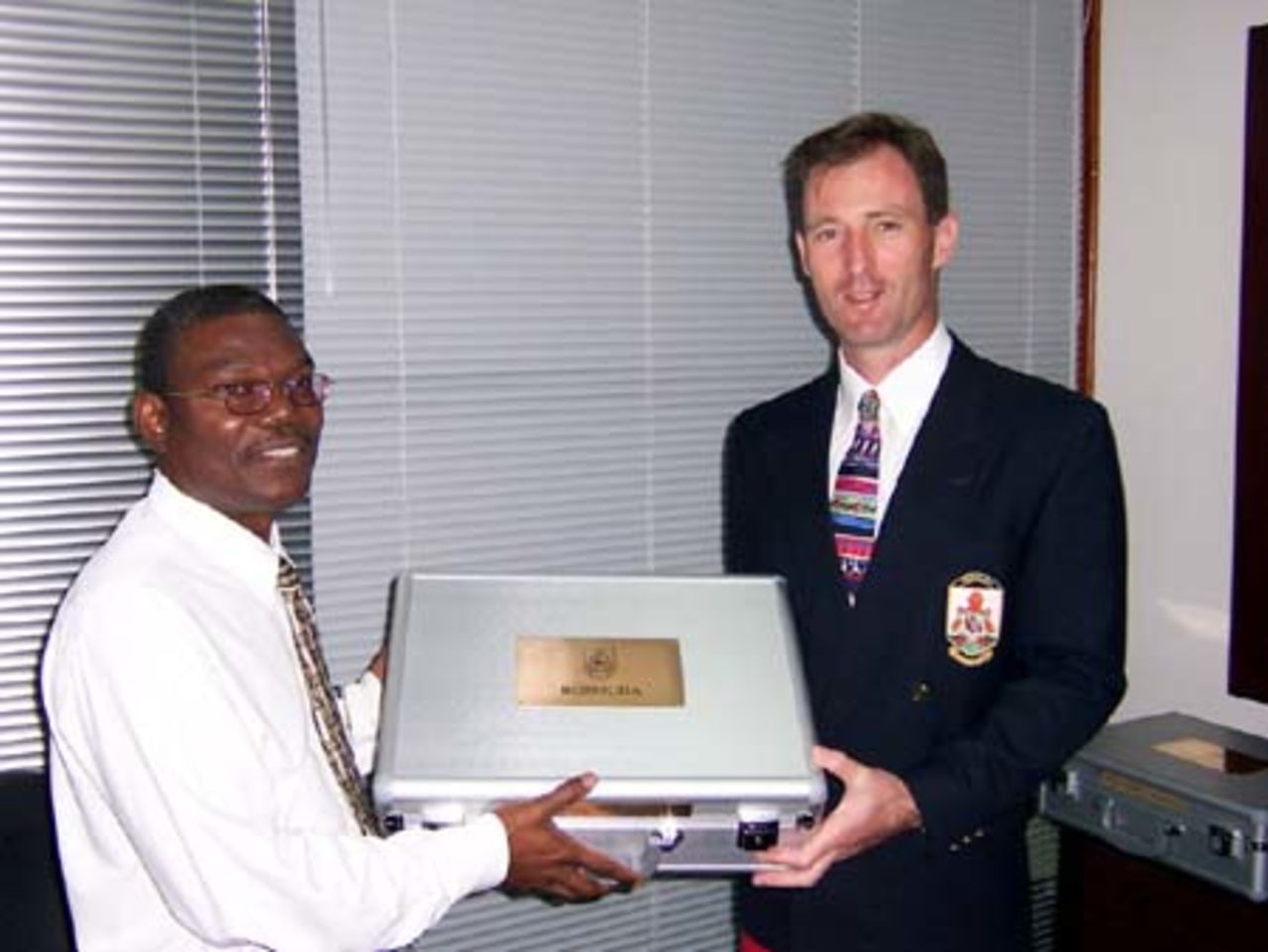 Neil Speight CEO, Bermuda Cricket Board handing over the BCB's WC2007 bid to Mr Lindell Nurse of the firm PWC in Barbados