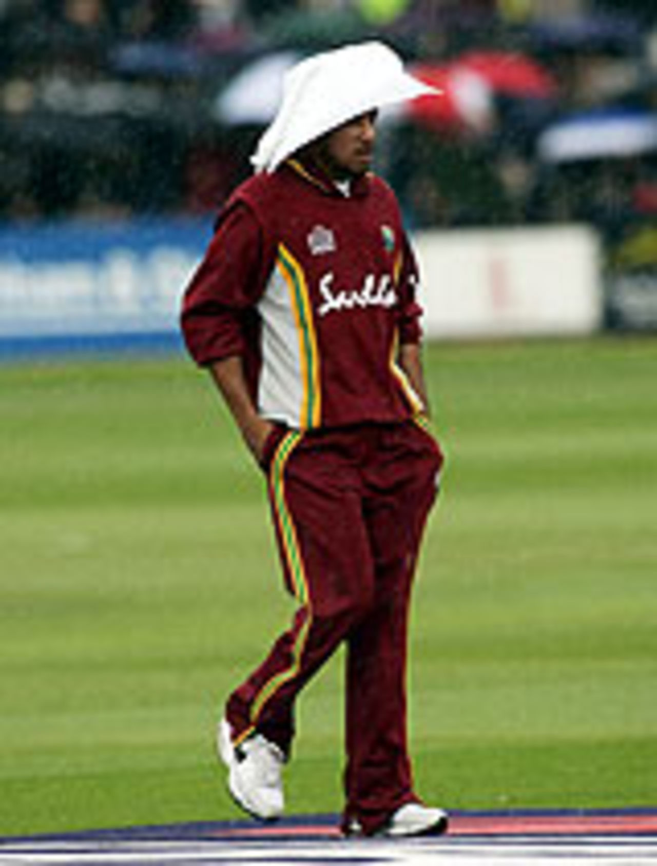 Ramnaresh Sarwan takes shelter from the drizzle, New Zealand v West Indies, Lord's, July 10, 2004
