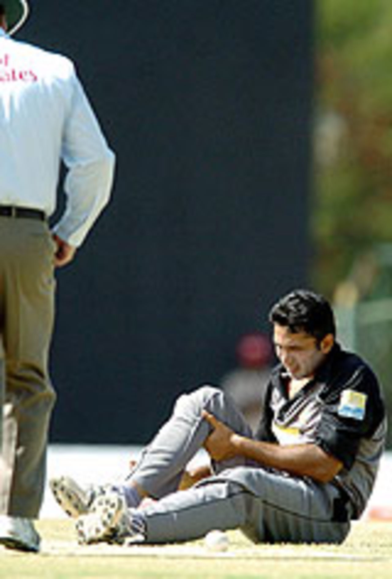 Asim Saeed grimaces after twisting his left knee, Asia Cup, 4th match, July 17, 2004