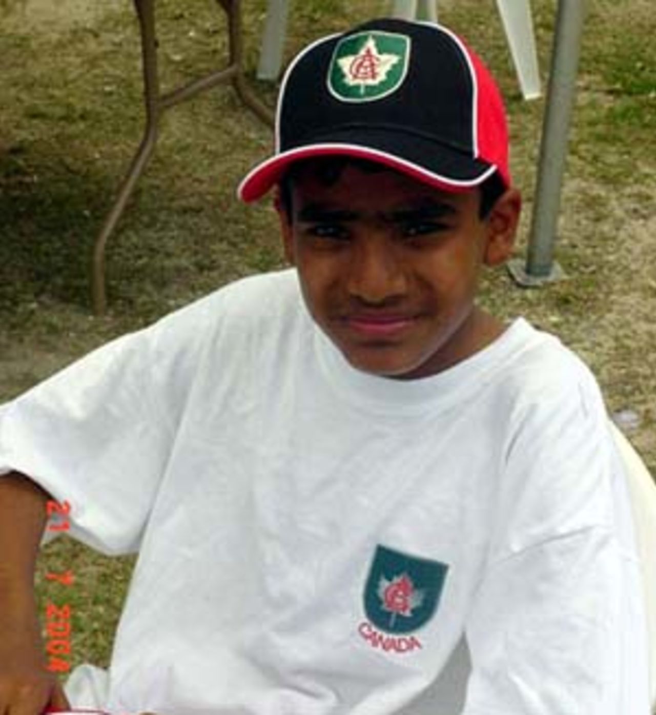 Rustam Ali Bhatti, 14 year old captain of Canada can only sit and hope the rain stops falling.