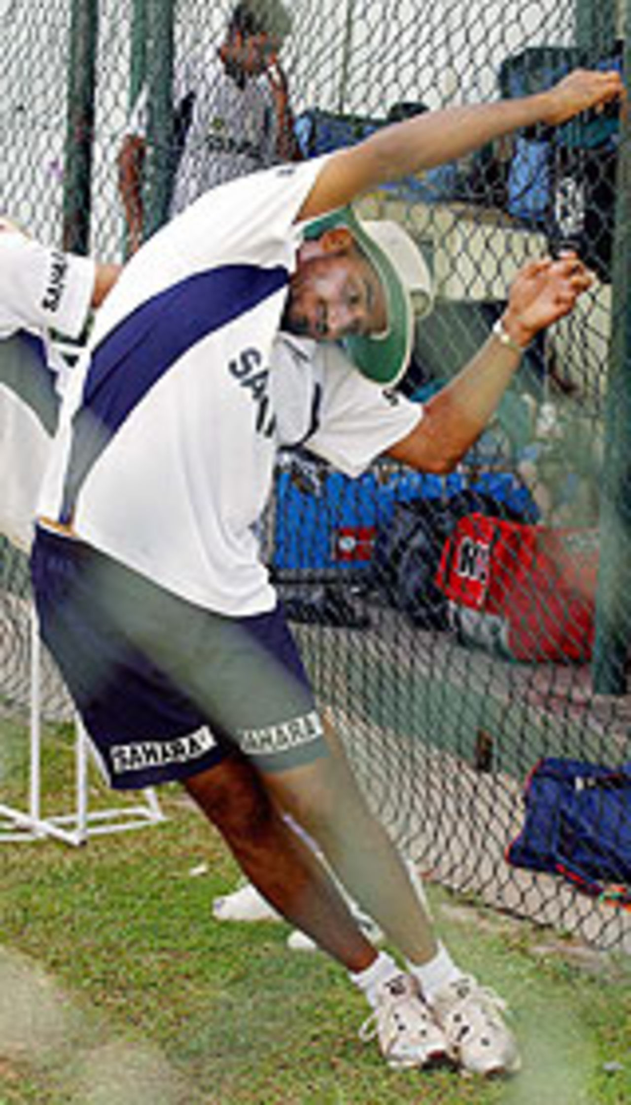 Harbhajan Singh stretches during practice, Colombo, July 30, 2004