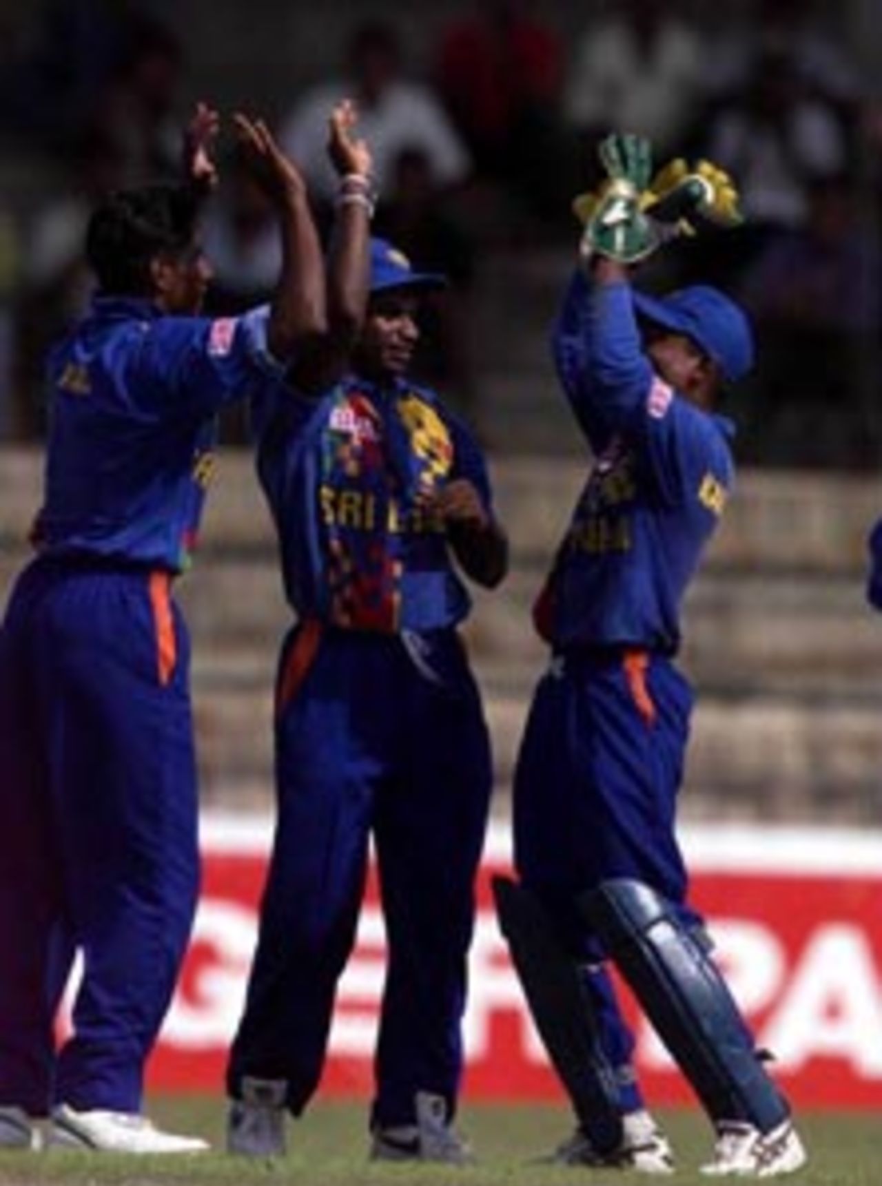 Chaminda Vaas (left) and Romesh Kaluwitharana of Sri Lanka celebrate after the dismissal of Raul Dravid of India, during the match between Sri Lanka and India at Premadasa Stadium, Colombo, Sri Lanka.