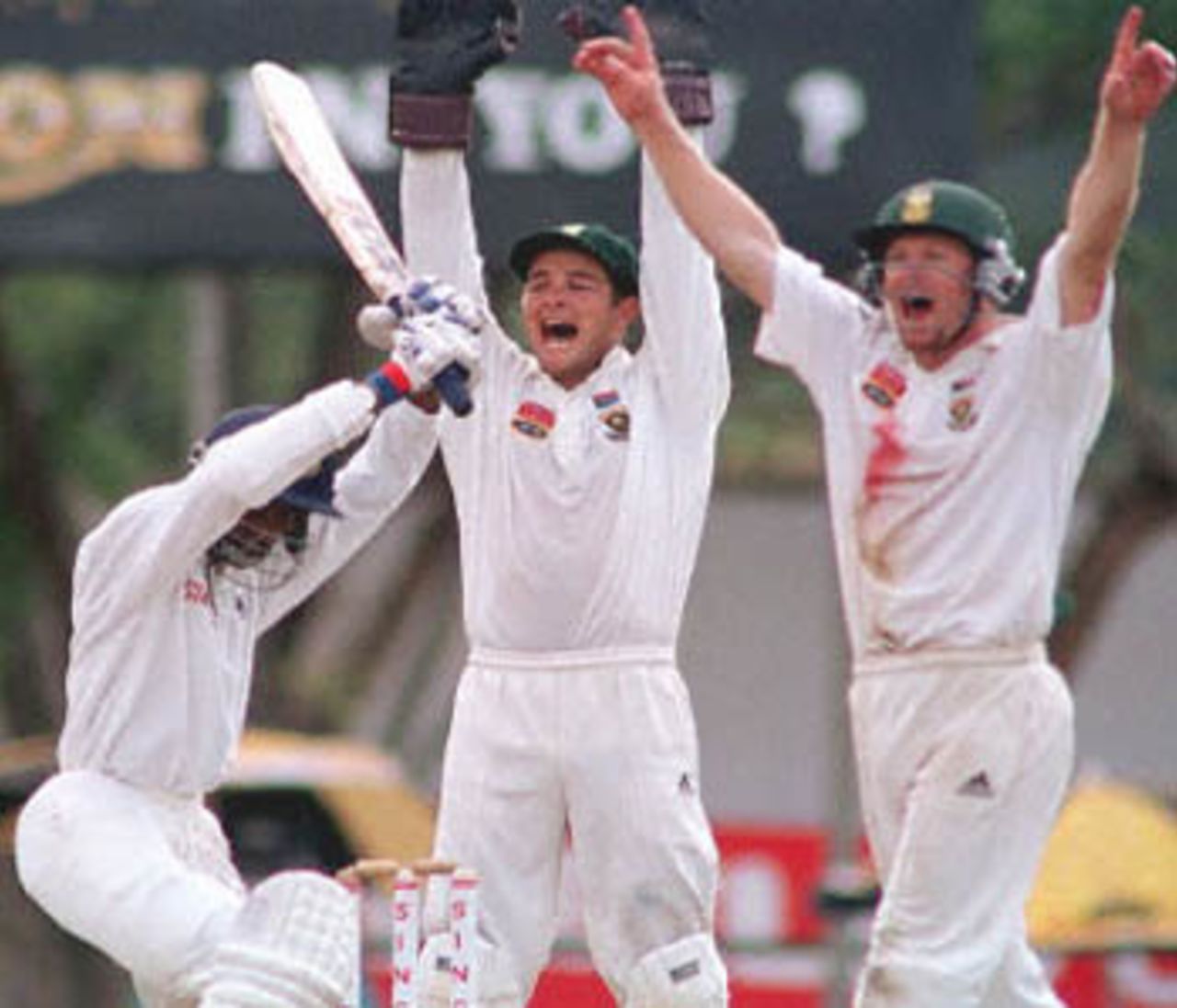 South African wicket keeper Mark Boucher (C) and fielder Jonty Rhodes (R) appeal unsuccessfully for an LBW decision against Sri Lankan one drop batsman Russell Arnold during the second day's play of the second cricket test between South Africa and Sri Lanka. Sri Lanka continued to finish the second day strongly placed at 260 for four wickets in reply to South Africa's 253. South Africa in Sri Lanka, 2000/01, 2nd Test, Sri Lanka v South Africa, Asgiriya Stadium, Kandy, 30July-03August 2000 (Day 2).