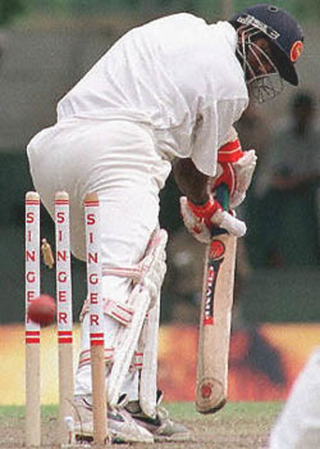 Sri Lankan batsman Muttaiah Muralidharan is bowled out by South Africa's Kallis during the third day of the second cricket test between South Africa and Sri Lanka. Sri Lanka scored 308 runs for the first innings reply to South Africa's 253 runs. South Africa in Sri Lanka, 2000/01, 2nd Test, Sri Lanka v South Africa, Asgiriya Stadium, Kandy, 30July-03August 2000 (Day 3).