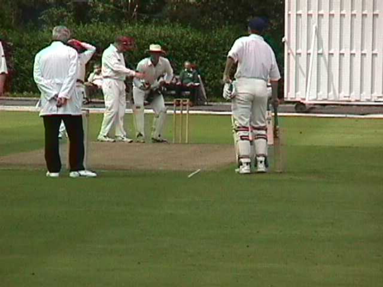 Haslingden fielders inspect the timbers after Stuart Priestley's amazing early escape