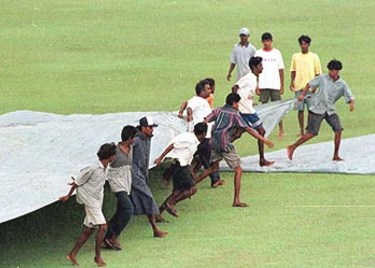 The ground staff at Sinhalese Sports Club scurring to cover the pitch, South Africa in Sri Lanka, 2000/01, 3rd Test, Sri Lanka v South Africa, Sinhalese Sports Club Ground, Colombo, 06-10 August 2000 (Day 4).