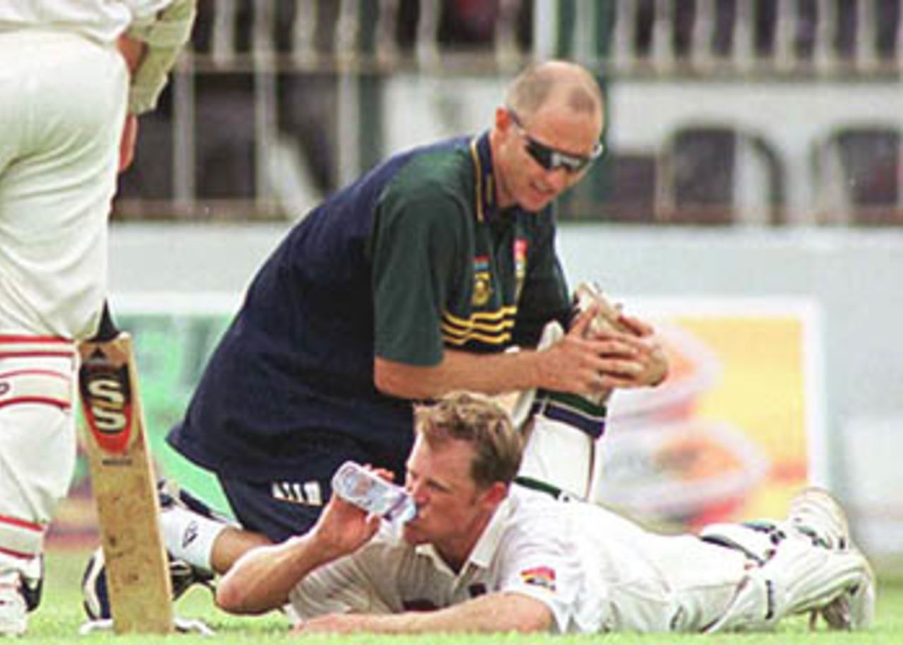 Rhodes takes a welcome breather as the team physio attends on him, South Africa in Sri Lanka, 2000/01, 3rd Test, Sri Lanka v South Africa, Sinhalese Sports Club Ground, Colombo, 06-10 August 2000 (Day 4).