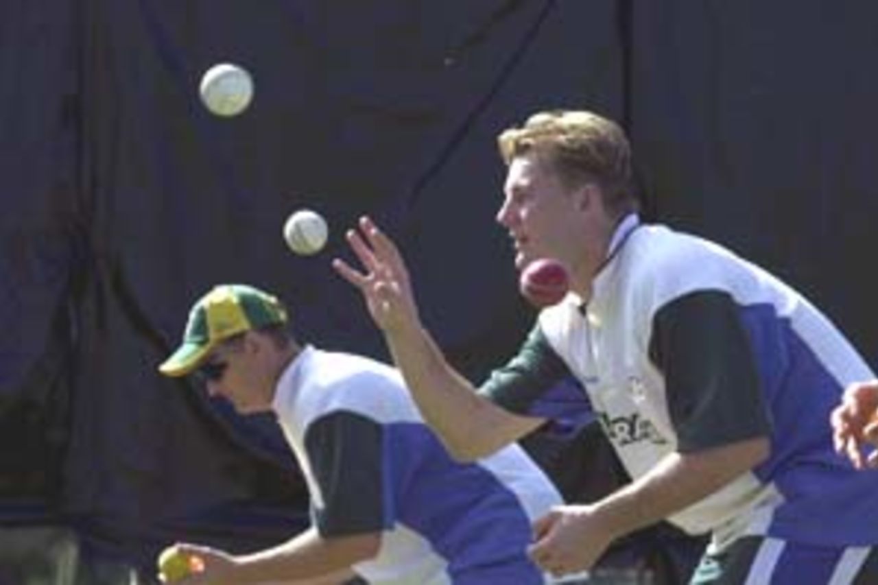 10 Aug 2000: Shane Lee and Adam Gilchrist of Australia in action at training for the Australian Cricket team at Allan Border Field in Brisbane, Australia. The Australian team are preparing for Super Challenge 2000 against South Africa.