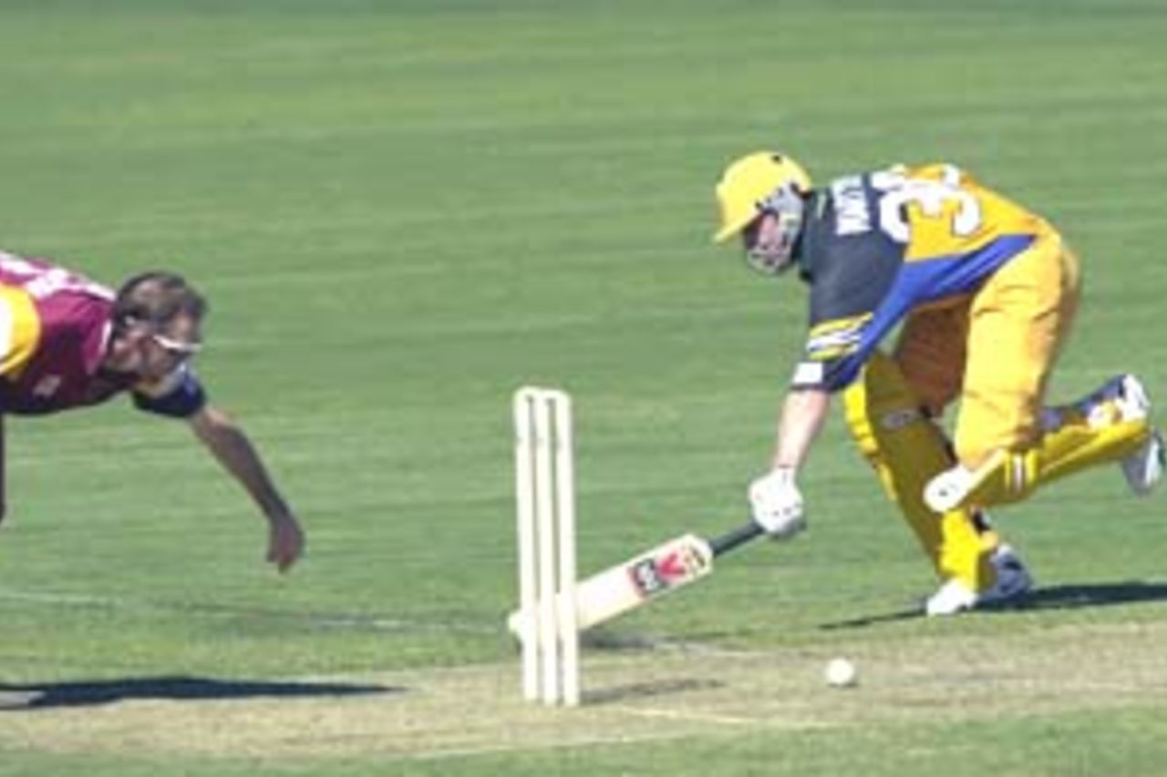 11 Aug 2000: Damien Martyn of Australia is nearly run out by Matthew Anderson of Queensland during the Australia versus Queensland practice match played at Allan Border Field in Brisbane, Australia. The Australian team are playing the practice match to prepare for the Super Challenge 2000 against South Africa