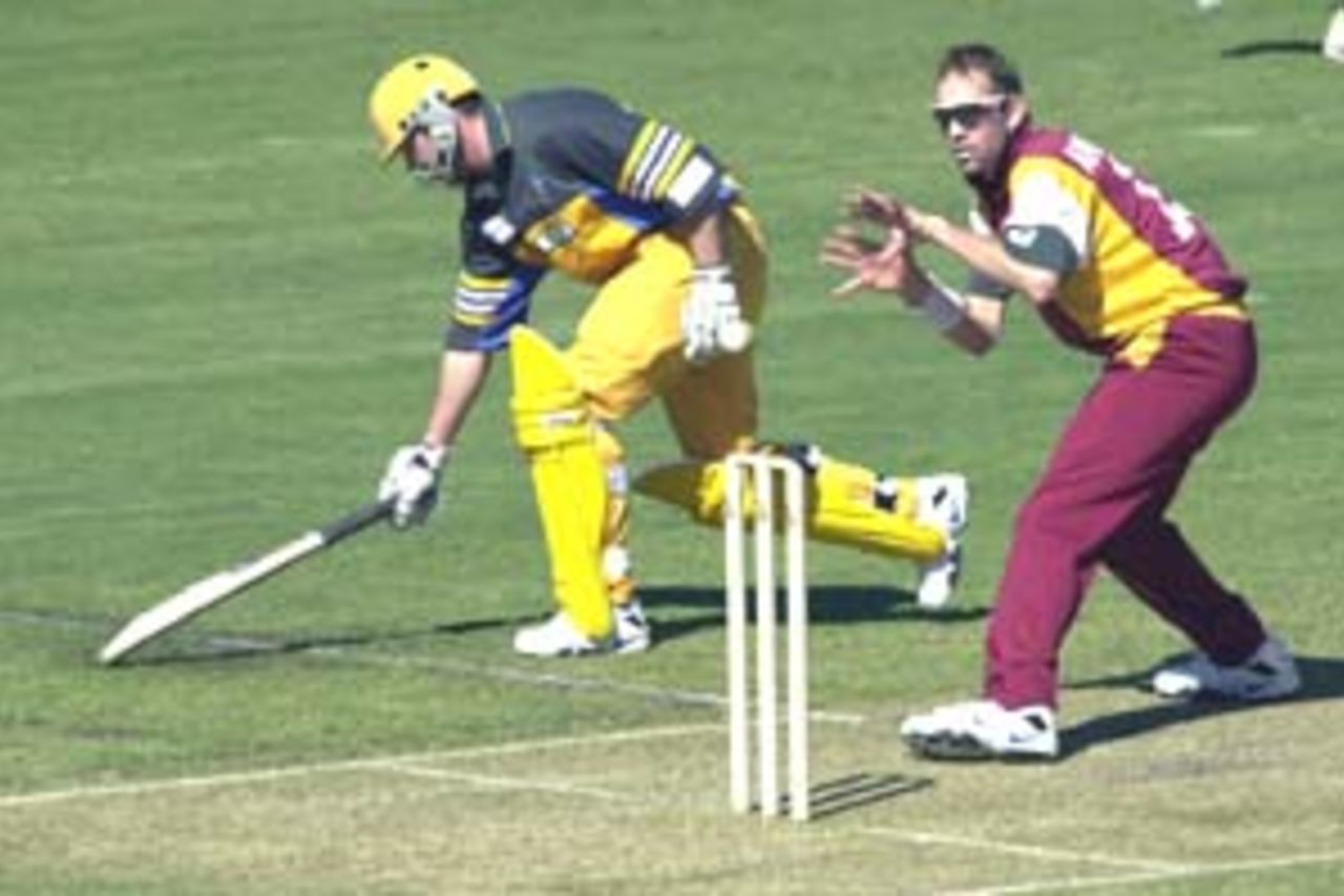 11 Aug 2000: Damien Martyn of Australia is nearly run out by Matthew Anderson of Queensland during the Australia versus Queensland practice match played at Allan Border Field in Brisbane, Australia. The Australian team are playing the practice match to prepare for the Super Challenge 2000 against South Africa.