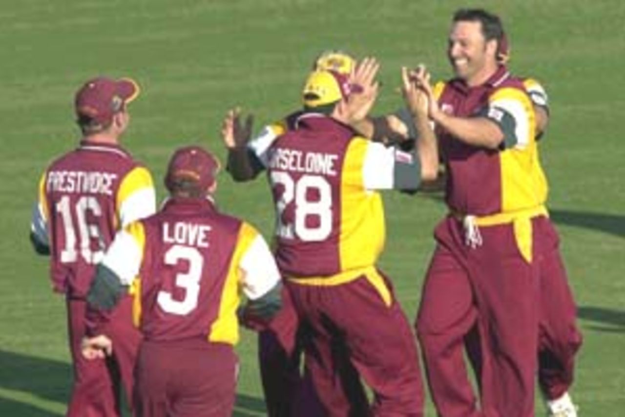 13 Aug 2000: Scott Prestwidge of Queensland celebrates with team mates after getting the wicket of Shane Warne of Australia during a practice match at Allan Border Field in Brisbane, Australia. The Australian team are playing the practice game against Queensland in Brisbane to prepare for the Super Challenge 2000 against South Africa.