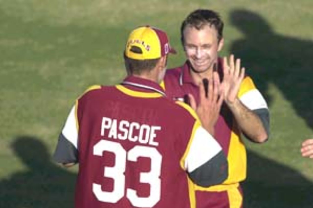 13 Aug 2000: Dale Turner of Queensland celebrates with team mate Matthew Pascoe after getting the wicket of Andrew Symonds of Australia during a practice match at Allan Border Field in Brisbane, Australia. The Australian team are playing the practice game against Queensland in Brisbane to prepare for the Super Challenge 2000 against South Africa.