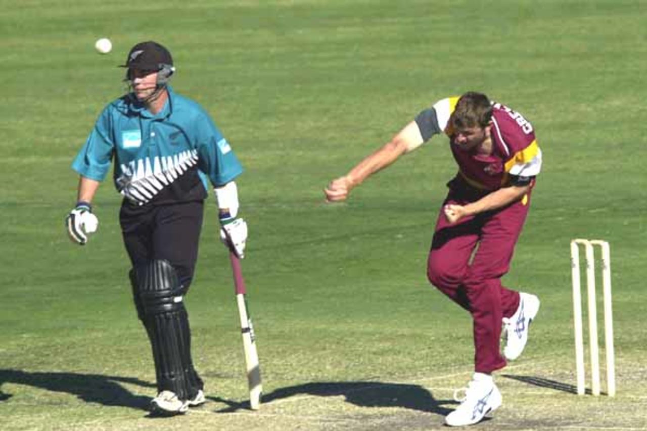 15 Aug 2000: Brendan Creevey of Queensland in action bowling while Craig McMillan of New Zealand looks on during the New Zealand versus Queensland practice match at Allan Border Field in Brisbane, Australia. Queensland won the game by 23 runs.