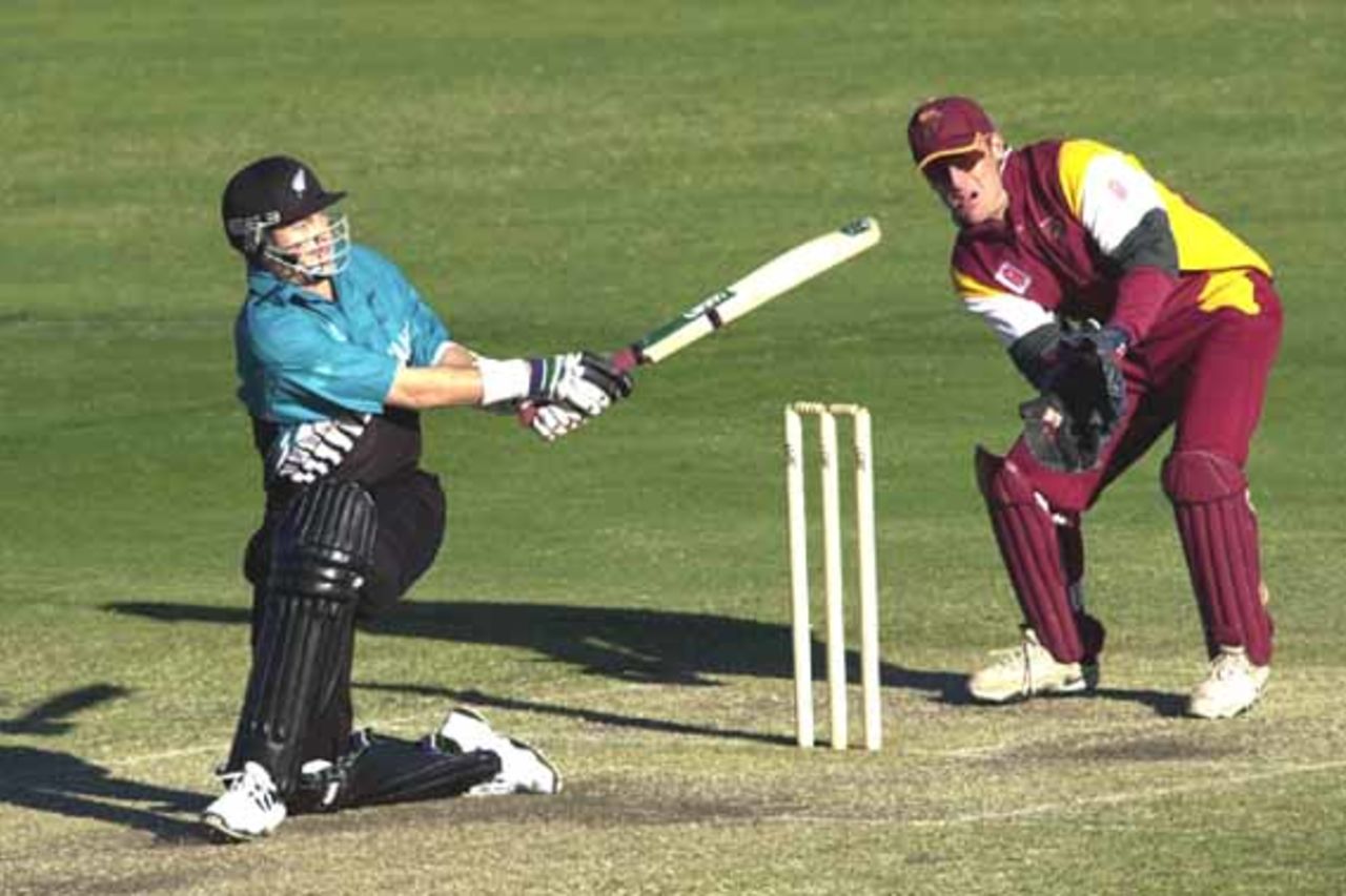 15 Aug 2000: Shayne O'Connor of New Zealand hits a shot past Wade Seccombe of Queensland during the New Zealand versus Queensland practice match at Allan Border Field in Brisbane, Australia. Queensland won the game by 23 runs.