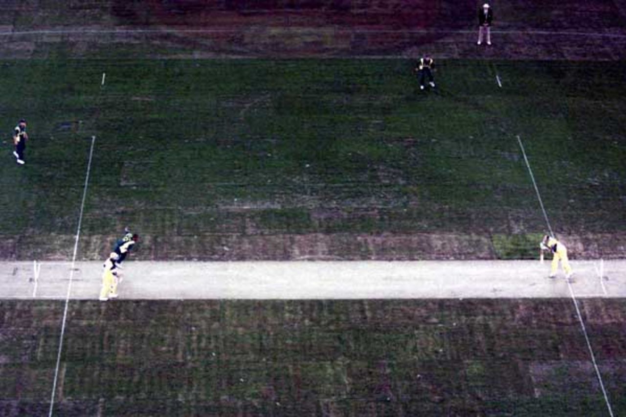 16 Aug 2000: Roger Telemachus of South Africa comes in to bowl to Adam Gilchrist of Australia in game one of the Super Challenge 2000 between Australia and South Africa, played at Colonial Stadium in Melbourne, Australia. This is the first game of cricket to be played indoors.