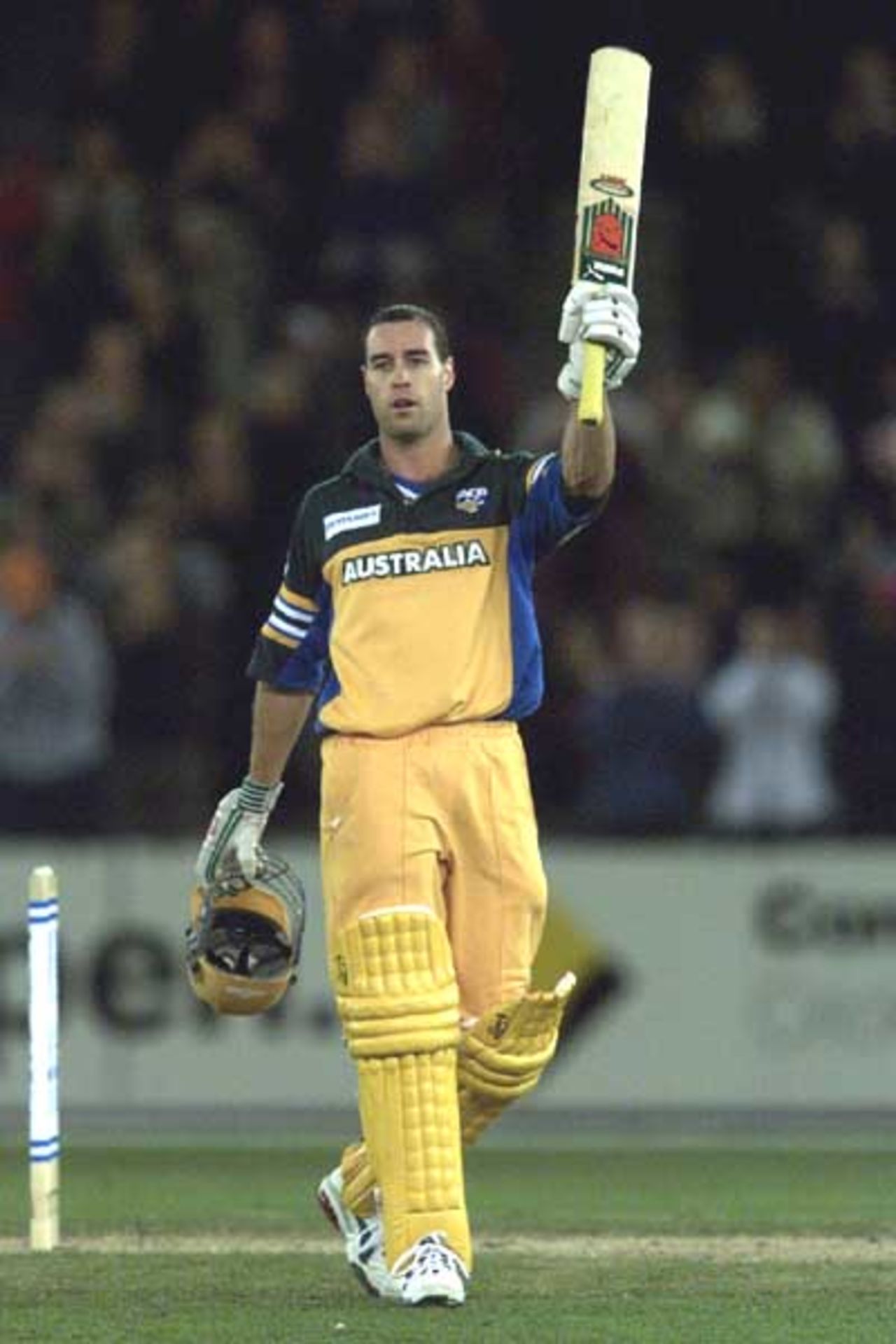 16 Aug 2000: Michael Bevan of Australia celebrates making 100 runs, in the match between Australia and South Africa, in game one of the Super Challenge 2000, played at Colonial Stadium in Melbourne, Australia. This is the first game of cricket to be played indoors.