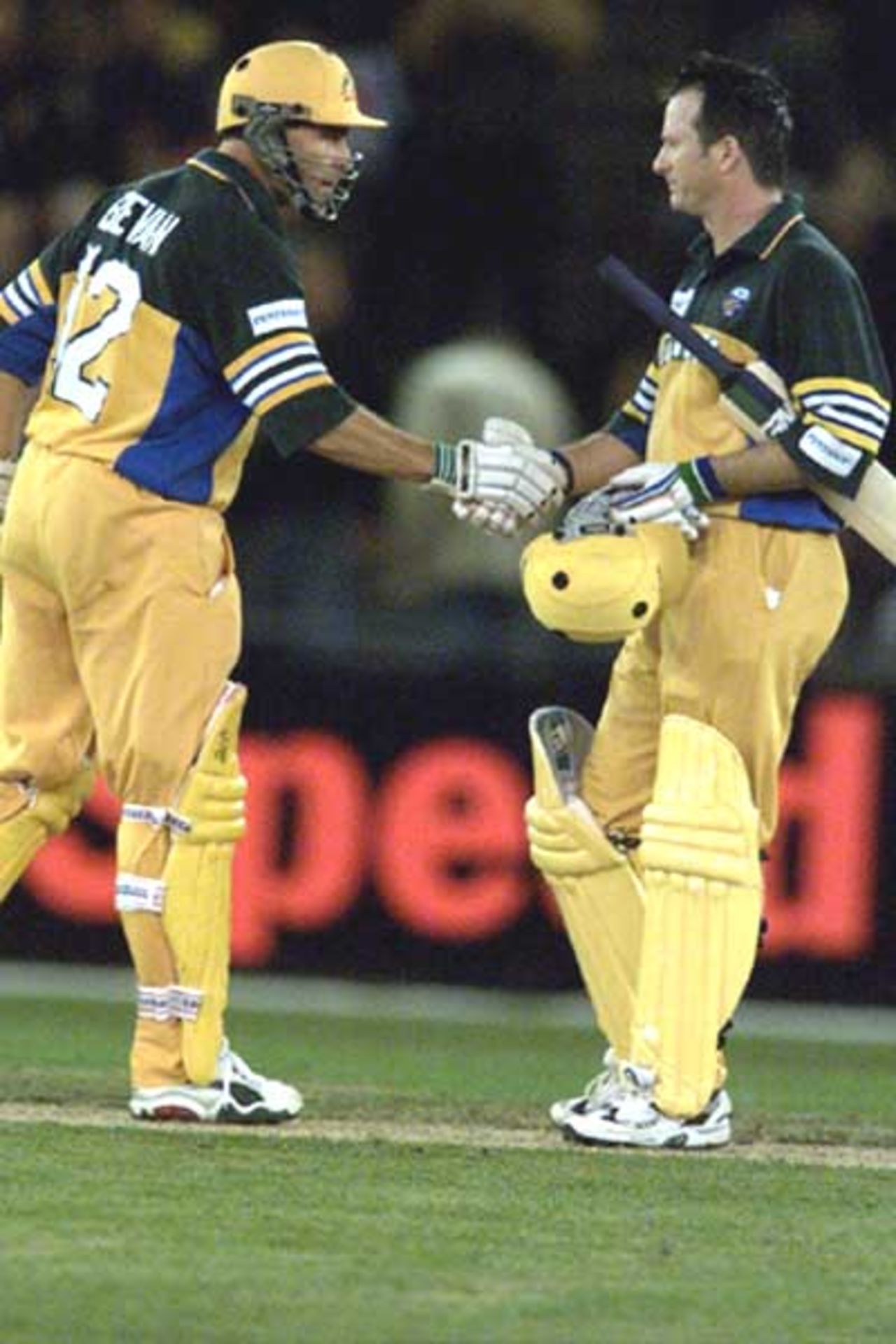 16 Aug 2000: Michael Bevan and Steve Waugh of Australia congratulate each other on making 100 runs, in the match between Australia and South Africa, in game one of the Super Challenge 2000, played at Colonial Stadium in Melbourne, Australia. This is the first game of cricket to be played indoors.