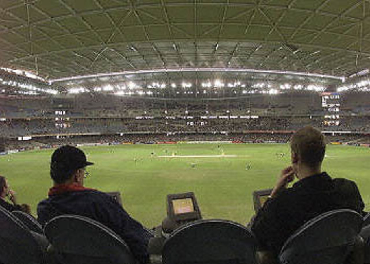 Cricket lovers take in the spectacle of the first one day cricket match in history to be played under a closed roof at the Colonial Stadium as Australia takes on South Africa in Melbourne. Being played in the middle of winter in Melbourne, Australia is 109-3 in the 23rd over with captain Steve Waugh and Michael Bevan at the wicket. South Africa in Australia, 2000/01, 1st One-Day International, Australia v South Africa, Colonial Stadium, Melbourne, 16 August 2000.