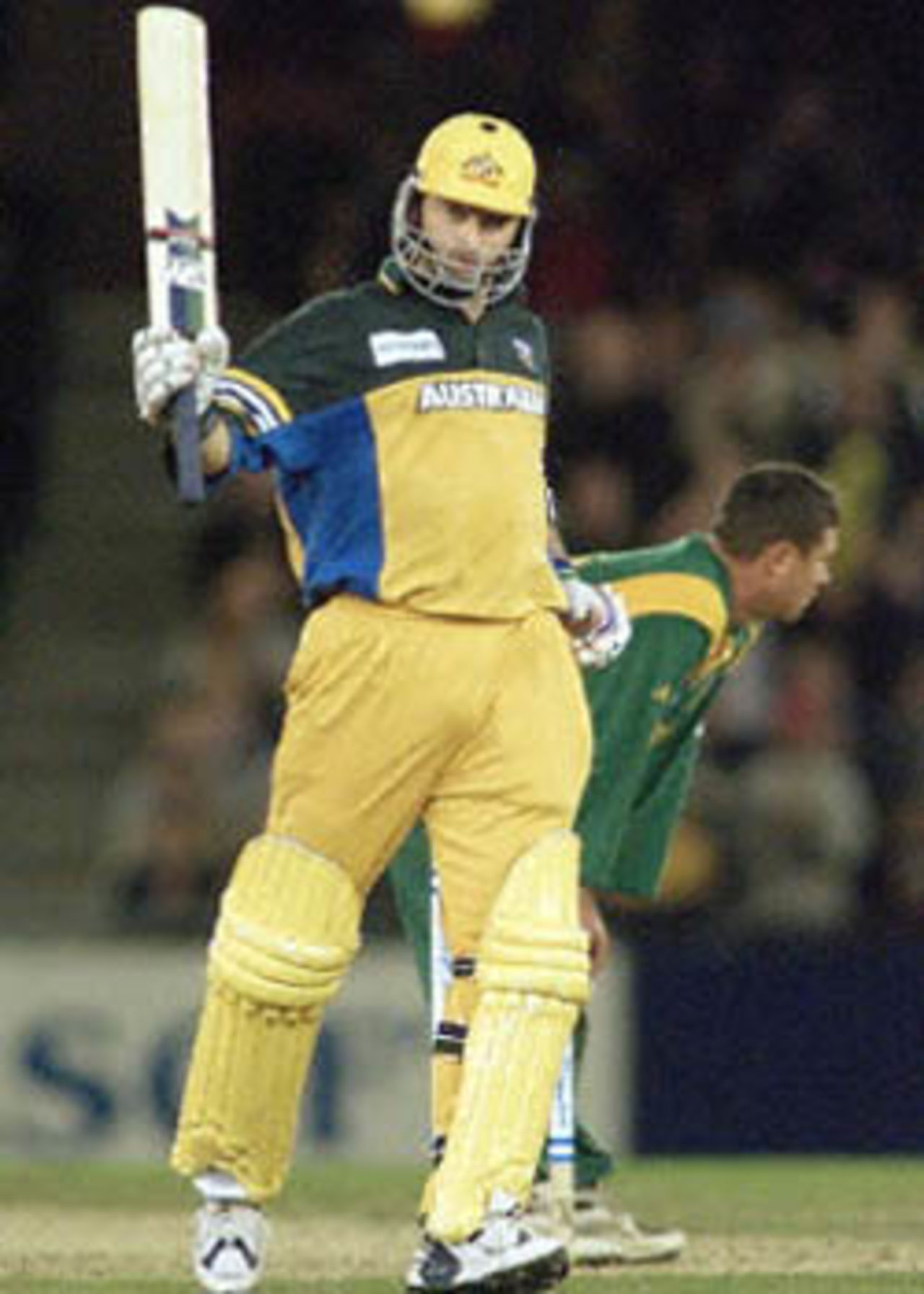 Australian captain Steve Waugh (L) acknowledges the applause from the crowd after scoring a century in the first one day cricket match in history to be played under a closed roof at the Colonial Stadium, as Australia takes on South Africa in Melbourne. Being played in the middle of winter in Melbourne, Australia scored 295-5 in their 50 overs with Waugh scoring 114 not out and Michael Bevan 106. South Africa in Australia, 2000/01, 1st One-Day International, Australia v South Africa, Colonial Stadium, Melbourne, 16 August 2000.